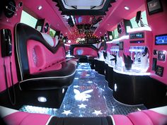 the inside of a limo with pink and black interior