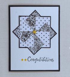 congratulations card with black and white designs on the front, yellow dots in the middle