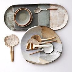 an assortment of wooden spoons, plates and bowls