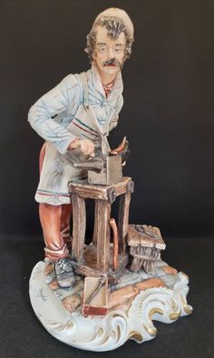 a figurine of a man working on a machine