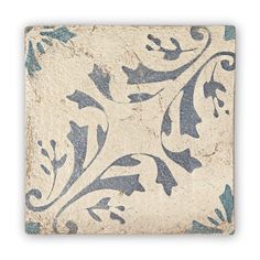 a square tile with blue and white designs on it