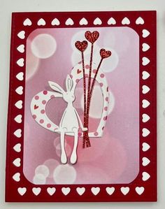 valentine's day card with bunny holding two heart shaped sticks and hearts on it