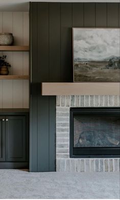 a living room with a fire place and bookshelves on the wall above it