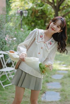 Long sleeve button up shirt with an oversized dual scalloped collar with eyelet crochet and embroidered flowers. Matching scalloped cuffs and flower buttons. S: 13.5" across shoulders, 37" chest, 23.5" lengthM: 14" across shoulders, 38.5" chest, 23.5" lengthL: 14.5" across shoulders, 40" chest, 24" length