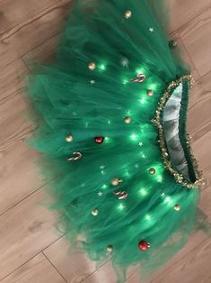 a green tutu skirt with lights on it and a tiara in the middle