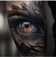 an eye with feathers on it is seen in this tattoo design by the artist,