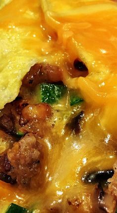 an omelet with meat, cheese and broccoli