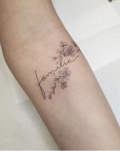 a woman's arm with flowers and the word, danielle written in cursive writing