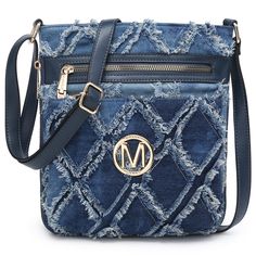 a blue cross body bag with the letter m on it