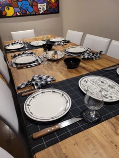 the table is set with black and white plates