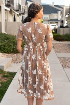 London is 5'8.5" and wearing a small - Runs TTS without stretch - size up if you need room in the bust - Elastic waist for comfortable fit - Incredible white and golden-brown embroidered floral overlay - Scalloped hem and edges of the sleeve - Fully lined and so unique! Product Measurements*Measurements are taken from side seam to side seamwhile laying flat. Small: Length: 44" Bust: 15" Waist: 14" Medium: Length: 44.5" Bust: 16" Waist: 15"Large: Length: 45" Bust: 17" Waist: 16"X-Large: Length: 4 Floral Overlay, Scalloped Hem, Golden Brown, Embroidered Dress, Medium Length, Elastic Waist, Comfort Fit, The Incredibles, London