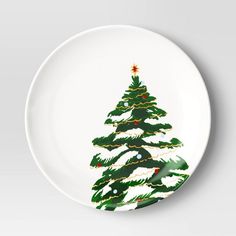 a white plate with a green christmas tree on it