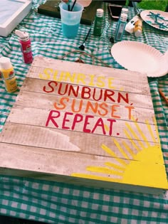 a wooden sign that says sunrise, sunburn, sunsett repeat on the table