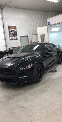 a black sports car parked in a garage