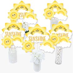 sunshine themed centerpieces are arranged in vases