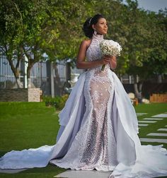 a woman in a wedding dress holding flowers