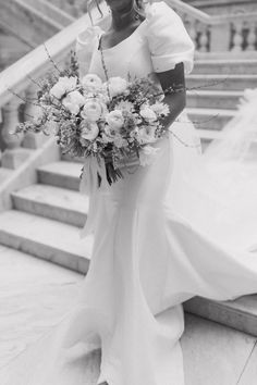 a woman in a wedding dress holding a bouquet