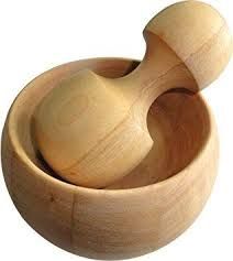 a wooden mortar and pestle in a bowl