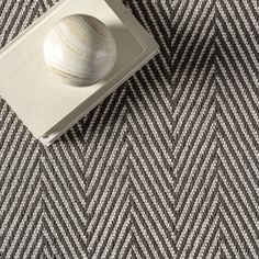 a close up view of a carpet with a white ball on the top of it