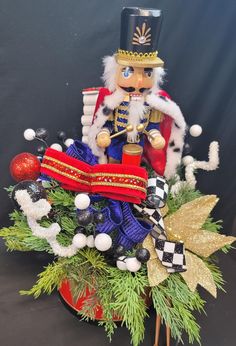 a nutcracker sitting on top of a christmas tree