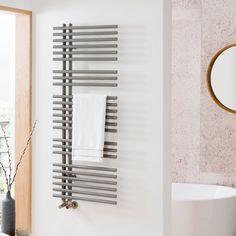 a bathroom with a sink, mirror and radiator in the wall next to it