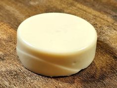 a white soap bar sitting on top of a wooden table