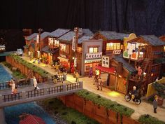 a model of a town with people walking around it