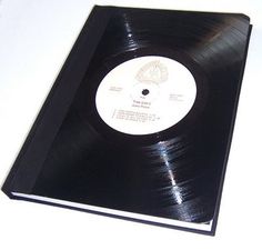 a black vinyl album with white disc on it