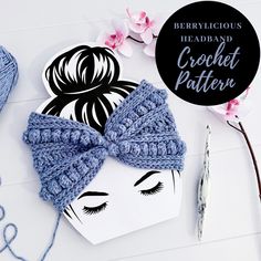 a crochet headband with a bow on it next to some knitting supplies