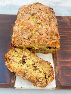 a loaf of fruit bread sitting on top of a cutting board