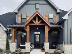 a gray house with wood trim and windows on the front door is featured in this article