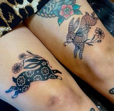 two people with tattoos on their legs