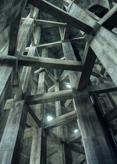 the ceiling is made up of wooden beams and has light shining through them on each side