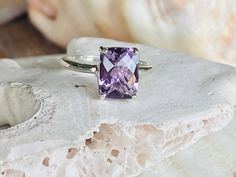 This classic solitaire setting contains a beautiful 2.00ct natural Rose De France amethyst. The antique cushion cut stone measures approximately 9x7mm and the band is 2mm wide. The ring is available in sterling silver, and 14k white, yellow, or rose gold. This ring makes a unique promise or engagement ring. Please send me a message if you need a size not listed. * This ring can be customized with any color center stone. All items are handmade by me in my shop in Woodbridge, NJ. Please message me Silver And Amethyst Ring, Luxury Lavender Amethyst Ring With Prong Setting, Classic Lavender Amethyst Ring With Prong Setting, Rectangular Purple Amethyst Ring, Classic Lavender Amethyst Ring, Classic Amethyst Solitaire Ring, Rectangular Purple Amethyst Ring With Prong Setting, Fine Jewelry Amethyst Ring With Rectangular Stone, Purple Rectangular Amethyst Ring With Prong Setting