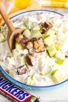 a bowl filled with cucumber salad next to a candy bar