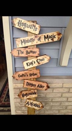 a wooden sign that says hogwarts, the mystery of magic and the king's cross