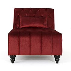 a red velvet chair with black legs and buttons on the armrests, against a white background