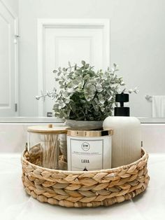 a wicker basket with soap, lotion and flowers in front of a mirror