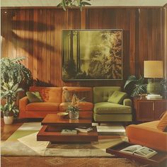 a living room filled with lots of furniture and plants on top of a wooden floor