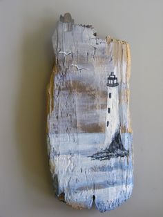 a piece of art with a lighthouse on it