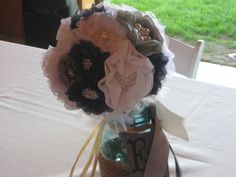 a vase filled with flowers sitting on top of a white table cloth covered tablecloth