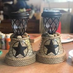 two small lamps sitting on top of a wooden table