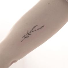 a woman's arm with a flower tattoo on it