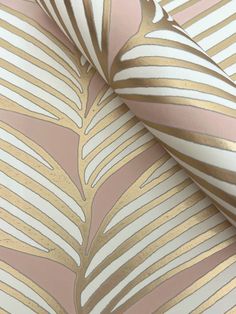 a pink and gold striped wallpaper with metallic leaf designs on the top, along with white stripes