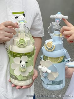 two people are holding baby bottles in their hands and one is holding an infant bottle