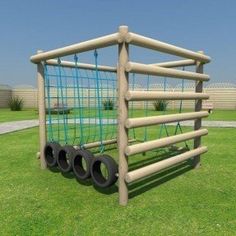 an outdoor play structure made out of wood and plastic tubes with wheels attached to it