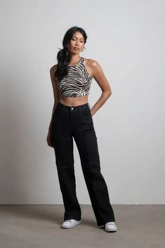 The Marina Del Rey Black Stitch Wide Leg Jeans are your new wardrobe staple. These high waisted jeans feature a front button and zipper closure, two front pockets, two back pockets, and exposed stitch details. Pair with an animal print crop tank top and tennis shoes for a laid-back, street aesthetic. Stitch Jeans, Black Stitch, Street Aesthetic, Jeans Wide