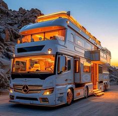 a double decker bus parked in front of some rocks