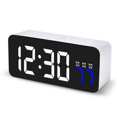 an alarm clock with blue numbers on the front and back sides is shown in white