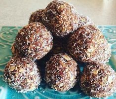 a pile of chocolate truffles sitting on top of a blue plate